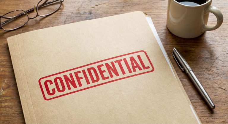 A close view of a document folder highlighting vawa confidentiality through a red stamp on the cover.